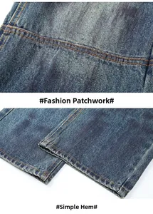 Detail of distressed blue denim jeans with orange stitching and flat hemmed cuff design
