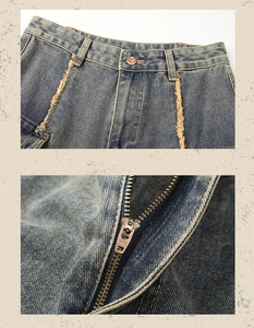 Detail of vintage blue denim jeans featuring premium YKK zipper and distressed seam finish