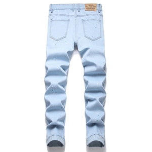 Men's light blue slim jeans with unique green and white paint splatter on the back