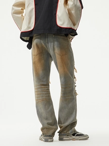 Vintage wash straight leg jeans for men with distressed holes and yellow tint mud effects