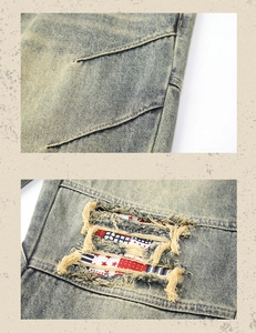 Detailed close-up of distressed denim with ripped knees and vintage star-patterned patches