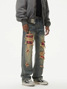 Men's vintage blue distressed jeans with red plaid patches and raw edge details