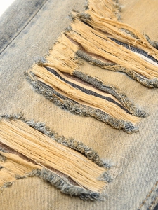 Vintage washed distressed jeans featuring heavy frayed hole details and a loose straight fit