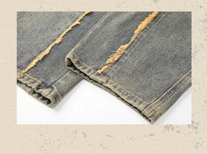 Close-up of light blue acid wash jeans with distinctive yellow tassel fringe details