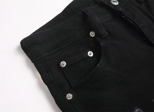 Detailed macro of black denim jeans waist with side pockets and silver metal rivets