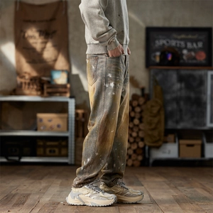 Retro washed straight-leg jeans with vintage yellow mud tint and paint splatter details