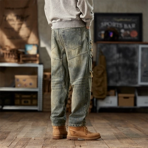 Men's retro distressed baggy jeans in washed blue with vintage rips and patchwork details