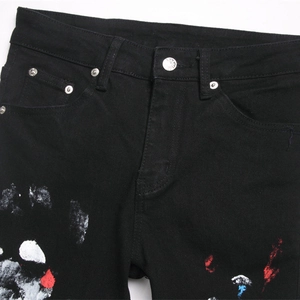 Men's black distressed jeans with multi-color paint splatter and silver button detail