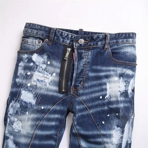 Men's blue distressed punk jeans with white paint splatters and slim fit design