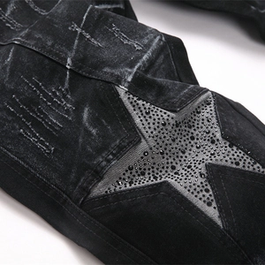 Slim fit black flare jeans for men with rhinestone star patches and distressed details