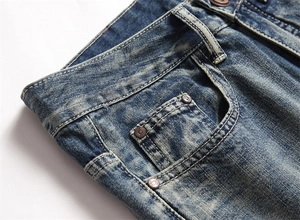 Detail der Taille und Taschen an verwaschenen blauen Denim-Jeans mit Bronzebeschlägen