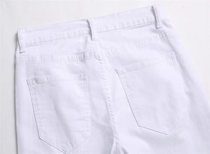 Detail view of white denim jeans rear pockets and high-quality stitching craftsmanship