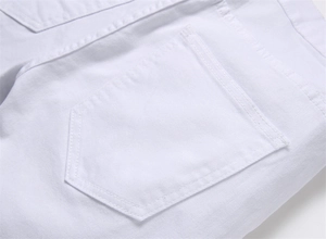 Macro shot of double-needle stitching on back pocket of white cotton denim jeans