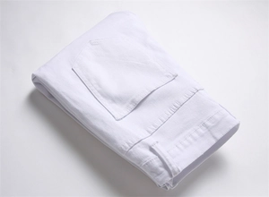 Detailed close-up of white high-density denim texture and stitching on men's slim jeans