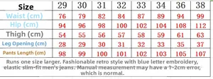 Detailed size chart for blue distressed slim fit men's jeans with embroidery details