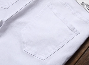 Close-up of white denim pocket showing double stitching and Jeans Classical label