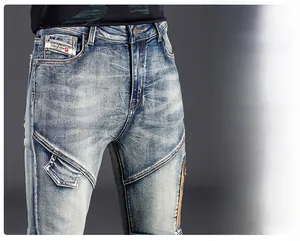 Detail view of men's slim fit blue jeans showing side zipper pocket and washed texture