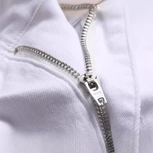 Close-up of white denim fabric with high-quality silver SBS metal zipper detail