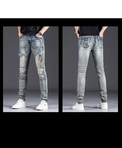 Detail view of slim fit light blue vintage wash jeans with cargo pockets and side zippers