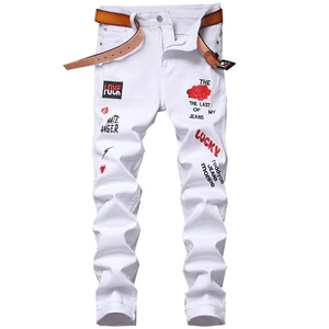 White slim fit men's street style jeans with colorful embroidery and a brown belt