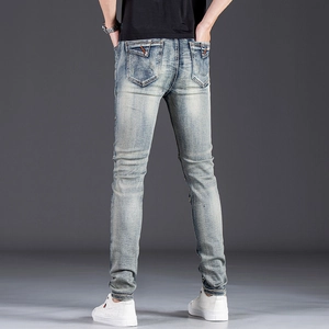 Slim fit light blue wash men's jeans with distressed details and contrast back pocket stitching