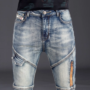 Men's slim fit blue distressed denim jeans with curved stitching and metal zippers