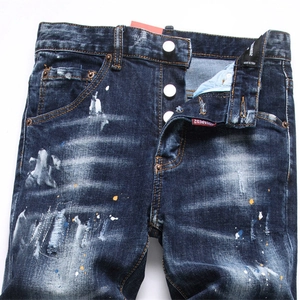 Jean slim pour hommes bleu foncé avec taches de peinture délavées et détails déchirés