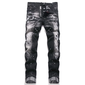 Distressed slim fit black denim jeans with ripped details and white paint splatters