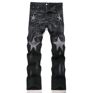 Slim fit black flare jeans with star patchwork and sparkling rhinestone details