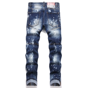 Macro view of distressed denim texture with white paint splatters and ripped details