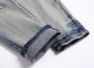 Macro detail of cuffed hem on vintage blue denim jeans with contrast yellow stitching
