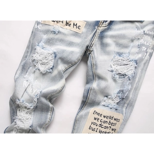 Men's blue distressed skinny jeans with street style patchwork and white letter graffiti