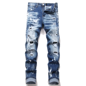 Men's blue high street slim fit ripped denim jeans with paint splatters and black patches