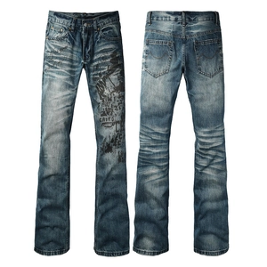 Detail view of mid-wash blue flared jeans with street-style graphics and vintage letter prints