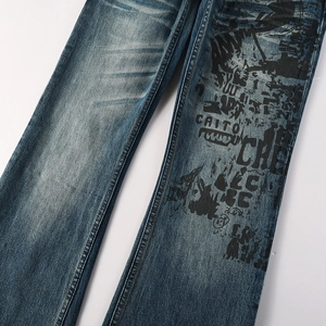 Detailed close-up of blue washed denim with black graffiti street style prints