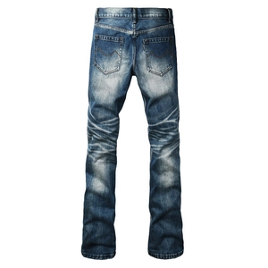 Detail view of washed blue denim back pockets with orange M-stitch embroidery and whiskering
