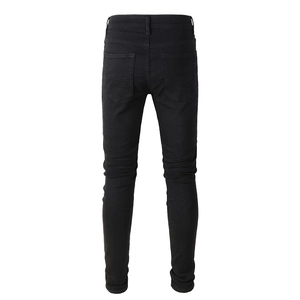 Rear view of slim fit black distressed denim pants with detailed back pockets for men