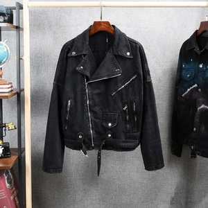 Detail of a black washed denim biker jacket featuring silver zippers and large lapels