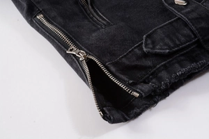 Detailed close-up of black denim biker jacket with metal zipper and frayed edge details