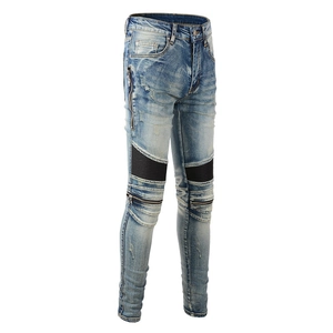 Detail view of moto jeans featuring knee panels, black mesh inserts and metallic zippers