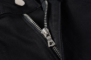 Macro shot of high-quality denim texture with silver metal zipper and button closure