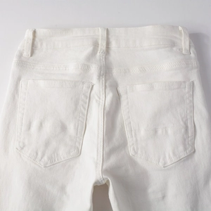 Close-up of the back waist and pocket stitching on white slim fit stretch denim jeans