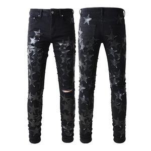 Slim fit black men's jeans featuring leather star patches and ripped denim details
