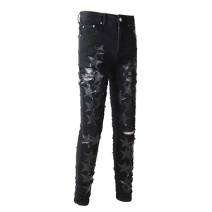 Slim fit men's black jeans with leather star patches and distressed knee details