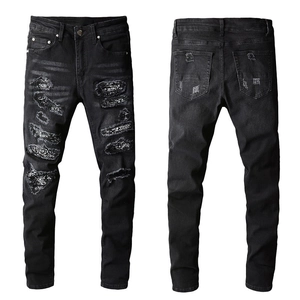Men's slim black distressed jeans with handmade patches and shiny sequin inner lining