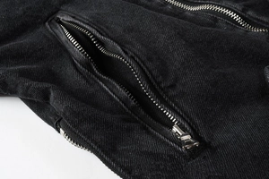 Macro shot of punk style denim jacket featuring metal zipper pocket and twill texture