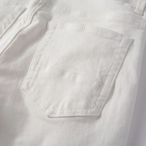 Detailed close-up of the white denim back pocket with precise reinforced stitching