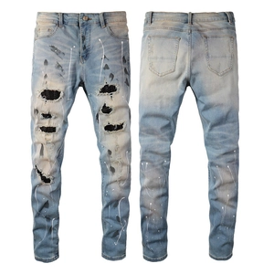 Men's slim fit light blue distressed jeans with retro wash, paint splatters and ripped details