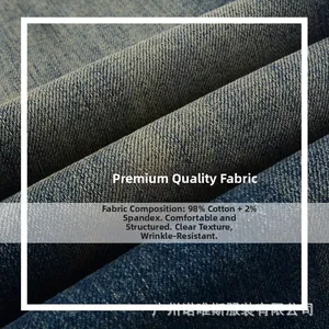 Macro shot of high-quality navy blue stretch denim fabric showing 98% cotton texture