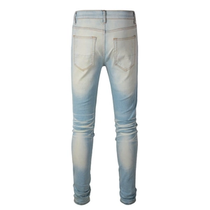 Detailed back view of light blue slim fit denim jeans showing pockets and washed texture